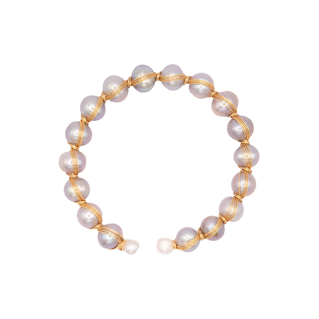 Pearl bracelet with gold wire on a white background
